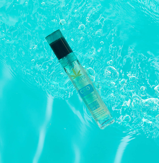 Hempz CBD Lip Service Nourishing Lip Conditioner SPF 15 floating in water